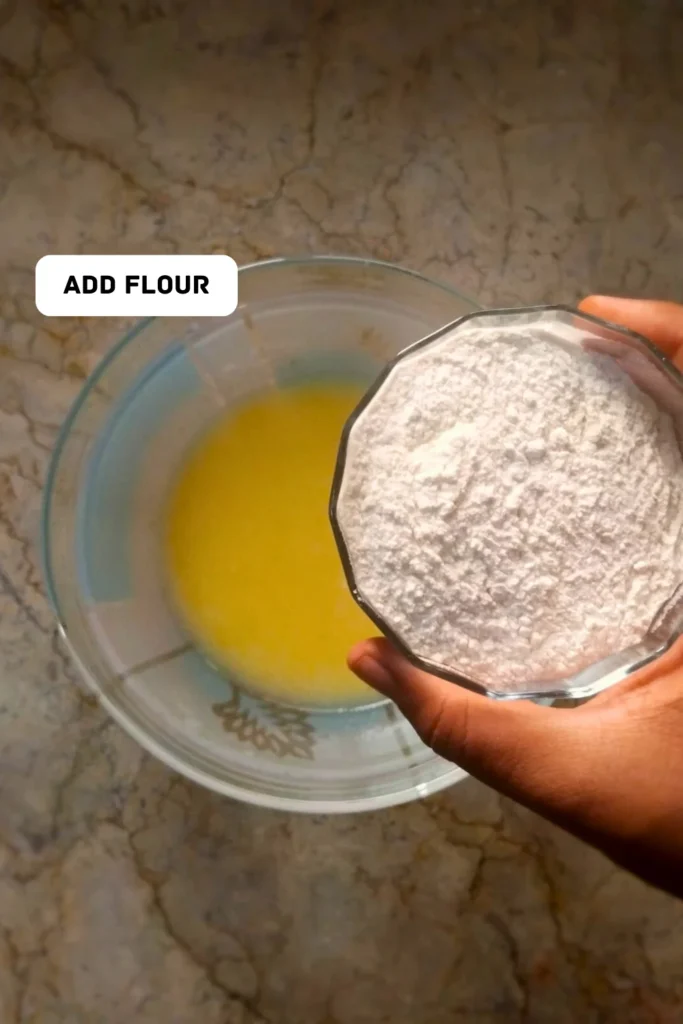 Add flour in muffin paste Add flour in muffin paste